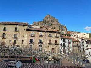 an old building with a mountain in the background at Morella, confort y excelentes vistas Casa Joanes in Morella