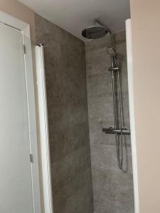 a shower in a bathroom with a glass door at Morella, confort y excelentes vistas Casa Joanes in Morella