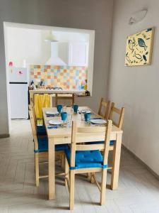 a kitchen with a wooden table with chairs and a table at Casa Gigé in Ustica