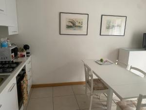 une cuisine avec une table blanche et un comptoir blanc dans l'établissement La casa di Giacomo con parcheggio, à Trieste