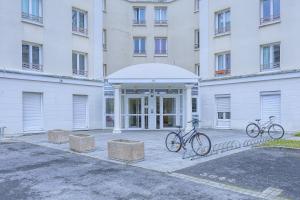 two bikes parked in front of a building at Cosy Mezzanine in Bussy-Saint-Georges