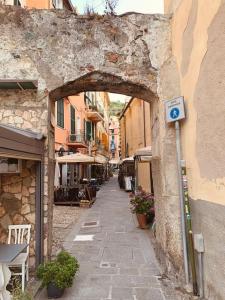a stone alley with an archway in a building at Historic Downtown Home By The Sea With King Bed in Monterosso al Mare