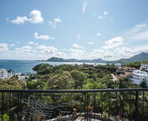 a balcony with a view of the ocean and buildings at Hotel Villas Los Angeles in Manzanillo