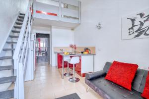 a living room with a couch and a table at Cosy Mezzanine in Bussy-Saint-Georges