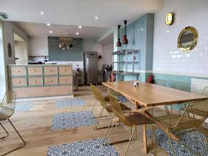 a dining room with a wooden table and chairs at Hotel Penzance Promenade in Penzance
