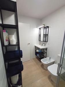 a bathroom with a toilet and a sink at Scorpio Golf Apartment in San Miguel de Abona