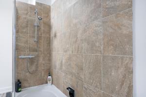 a bathroom with a shower and a bath tub at Quiet Neighborhood-Free Parking in Blackpool