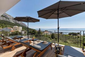 a view from the balcony of a house with umbrellas at Villa Teraco in Makarska