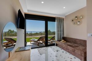 a living room with a couch and a large window at Villa Teraco in Makarska