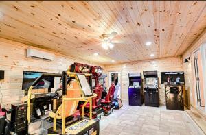 a garage with wooden ceilings and a room with machines at Dollys Retreat in Pigeon Forge