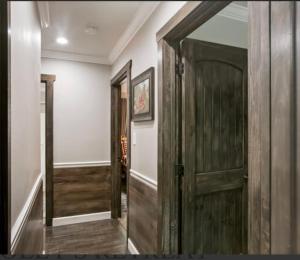 a hallway with a wooden door and a mirror at Dollys Retreat in Pigeon Forge