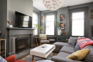 a living room with a couch and a fireplace at Hudson Valley Retreat in Downtown Hudson, NY - Sleeps 16-20 in Hudson