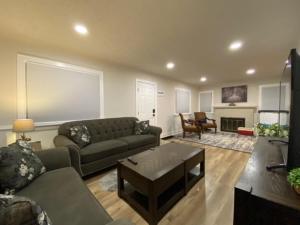 a living room with a couch and a table at Charming Brick Home with bonus space & foosball in Spokane