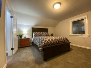 a bedroom with a bed and a window at Charming Brick Home with bonus space & foosball in Spokane