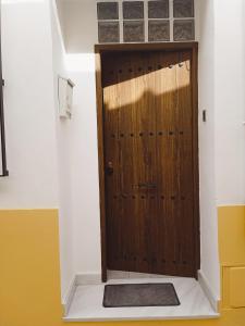 a wooden door in a room with a stair case at Apartamentos Lax in Almería