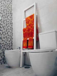 a bathroom with a toilet and a sink and towels at Apartamentos Lax in Almería +17 photos
