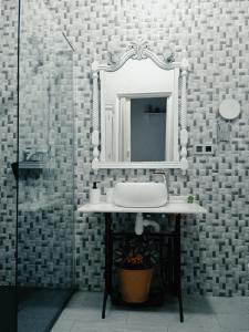 a bathroom with a sink and a mirror at Apartamentos Lax in Almería