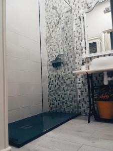 a bathroom with a glass shower and a sink at Apartamentos Lax in Almería