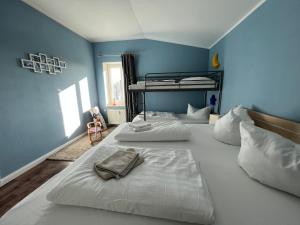 two beds in a room with two bunk beds at Meerblick Apartments Villa Vineta Göhren in Göhren