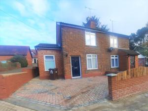 a red brick house with a brick driveway at 3 Bedroom Semi Detached House with parking, WiFi in Colchester