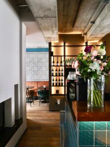 a kitchen with a vase of flowers on a counter at The Kepos Hotel Erlangen in Erlangen