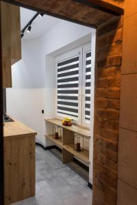 a kitchen with a window and a wooden table at Apartament Black Loft in Nysa