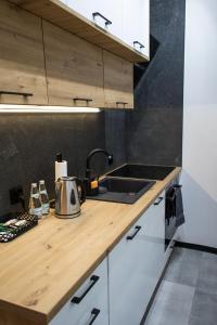 a kitchen with a sink and a counter top at Apartament Black Loft in Nysa