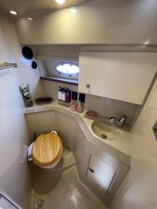 a small bathroom with a toilet and a sink at Yacht( boat )2 Beds, 1 Bath Dubai Eye Marina JBR in Dubai