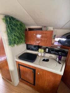 a small kitchen with a sink in a trailer at Yacht( boat )2 Beds, 1 Bath Dubai Eye Marina JBR in Dubai