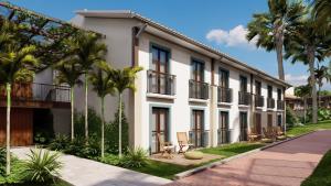 a building with palm trees in front of it at Eco Resort Quinta Santa Bárbara in Pirenópolis +4 photos