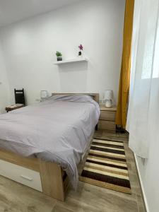 - une chambre avec un lit et un tapis dans l'établissement New Two bedroom flat Kamila on a dwell, à Sliema