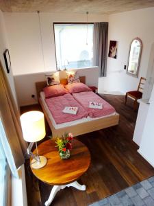 a small bedroom with a bed and a table at Cologne Country Lodge in Cologne