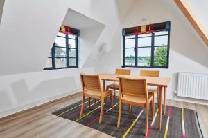 a dining room with a wooden table and chairs at The Penthouse in King's Lynn