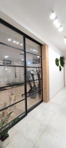 an empty office with large windows and plants at Cozy Rooms Luna - Home Gym in Zadar