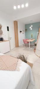 a bedroom with a bed and a dining room at Cozy Rooms Luna - Home Gym in Zadar