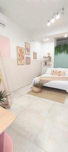 a white room with a bed and a window at Cozy Rooms Luna - Home Gym in Zadar