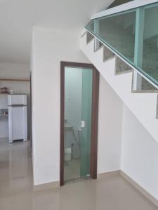 an empty room with a staircase and a glass door at La casa de Luna in Guaibim