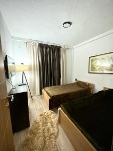 a hotel room with two beds and a window at ANKA APARTMENT in Štip