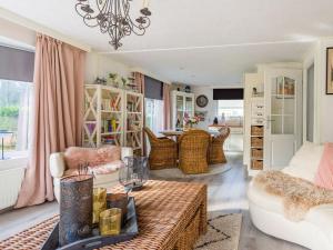 a living room with a couch and a table at Lovely chalet in Hoek with terrace in Hoek