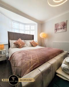 een slaapkamer met een groot bed met kussens erop bij Large 5 BRH for Contractors,Families and Business free parking in Birmingham