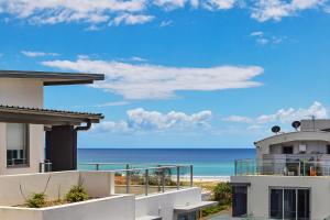 a view of the beach from the balcony of a house at Coastal Souls North Kirra Beach in Gold Coast