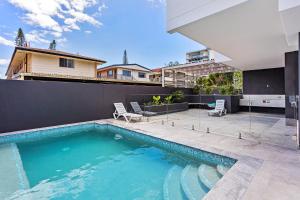 a swimming pool in the backyard of a house at Coastal Souls North Kirra Beach in Gold Coast