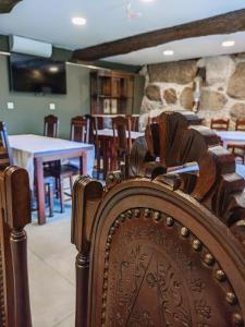 a wooden chair in a dining room with a table at Costeira Douro in Castelo de Paiva