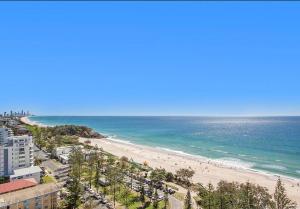 eine Luftansicht auf einen Strand und das Meer in der Unterkunft Burleigh Surf Apartments in Gold Coast