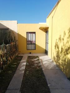 um edifício amarelo com uma janela do lado em Acogedora casa estilo mexicano em Dolores Hidalgo