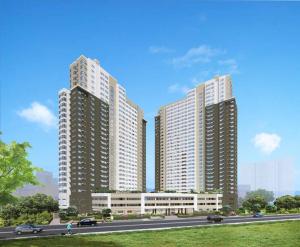 two tall buildings with a road in front of them at Keys N Places @ Avida Aspira in Cagayan de Oro