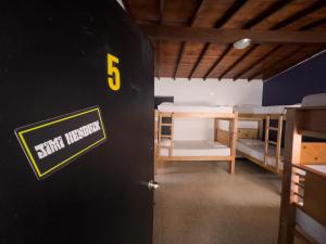 a room with five bunk beds in it at Rock Hostel Medellin in Medellín