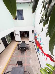 an empty room with tables and chairs in a building at Rock Hostel Medellin in Medellín