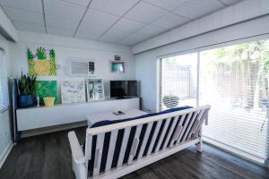 a room with a crib and a large window at Drop Anchor Resort & Marina in Islamorada