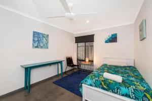 a bedroom with a bed and a desk at Vasse NewYorker Townhouse in Vasse